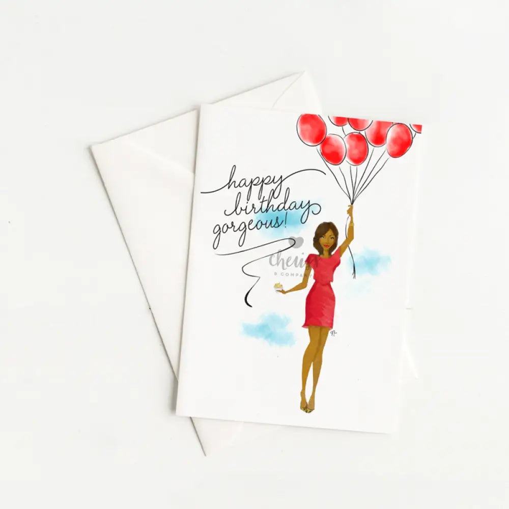 greeting cart with an illustration of an African American woman floating in the sky holding red balloons and a cupcake.